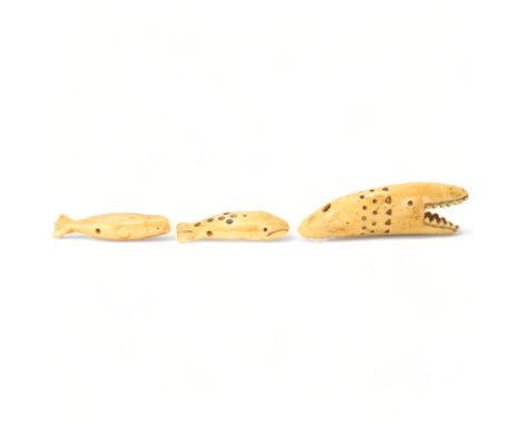 Three Inuit whale bone or tooth carvings, in varied whale forms, longest 8.5cmAll in good condition, some light surface crack
