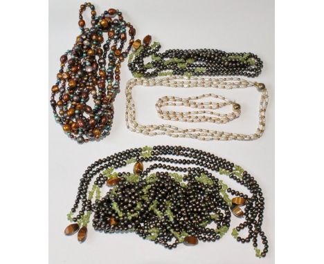 Four strings of black pearls with peridot, another, and a pearl necklet with bracelet.