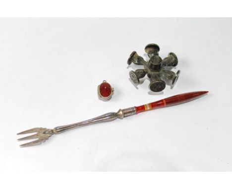 Victorian silver pickle fork with slender agate handle, a silver gilt and enamel basket charm with tiny figure of Moses, and 