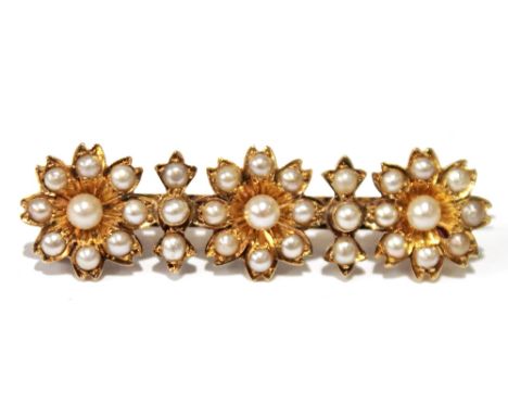 Victorian gold bar brooch with three pearl clusters, '15ct'. Condition Report Brooch is 42mm long.  Very good condition.
