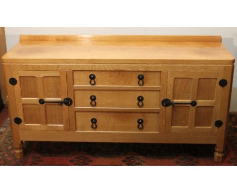 Robert 'Mouseman' Thompson of Kilburn oak sideboard having three central drawers flanked by two cupboard doors, raised on oct