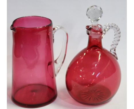 Victorian cranberry flask decanter with clear handle and stopper, 22cm high, and a cranberry jug with clear handle, 18cm high