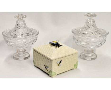 Crown Devon square honey pot with bee surmount, 13cm, and a pair of moulded glass candy jars and covers, 20cm high.  (3) Cond