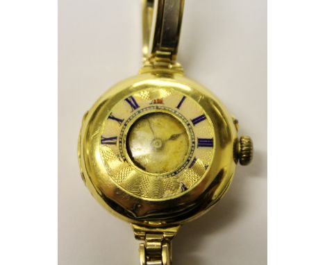 Lady's 18ct gold wristwatch (damaged enamel chapters) on yellow and white gold expanding bracelet.