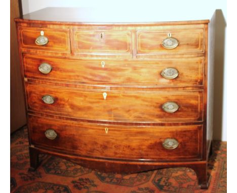 19th century bowfront mahogany chest of three short over three graduated long drawers raised on bracket feet, 116cm wide.