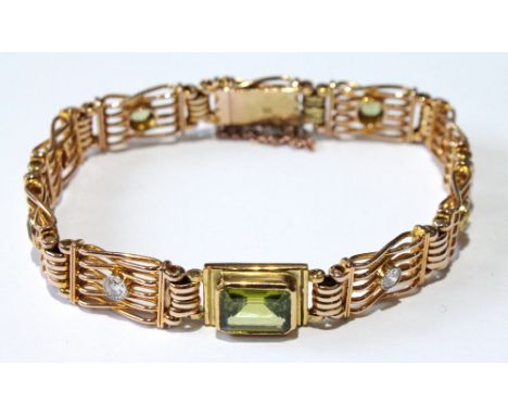 Attractive Victorian gate bracelet with a rectangular peridot and others smaller, collet-set, with flanking diamonds in gold,