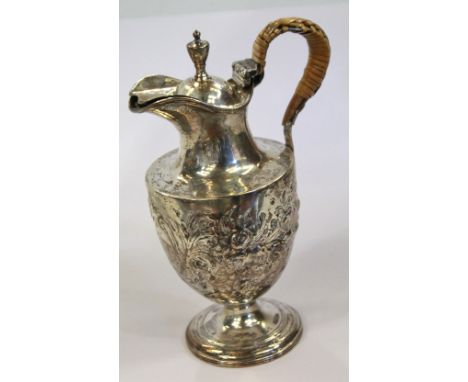 18th century embossed cream jug of urn form with floral decorated, hinged cover with finial, wicker-bound handle, by Thomas G