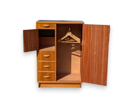 A 20th century compactum wardrobe, with a single door wardrobe to the right hand side, the left a series of drawers and compa