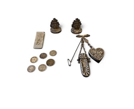 A small collection of silver items, to include a silver chatelaine, with floral brooch, heart shaped pin cushion, needle case