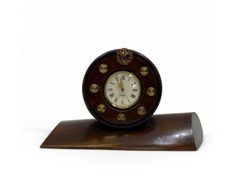 A WWI propeller mantle clock, constructed from the boss and blade of a wooden plane propeller, the dial centered at the top w