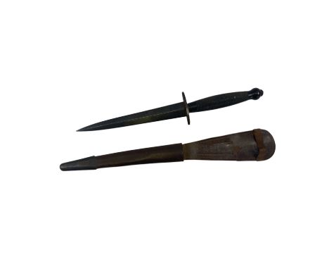 A Fairbairn-Sykes second pattern fighting knife, in black with knurled grip and broad arrow mark to grip beneath crossguard