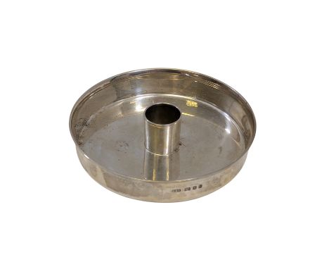 A silver candlestick, by Christopher Lawrence, London, 1968, of squat form, with a narrow sconce central to a wide drip pan, 