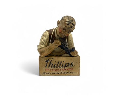 A Phillips advertising mascot, in the form of a cobbler repairing a shoe on a plinth base, inscribed "Philips STICK A SOLES A