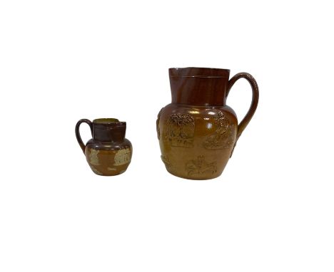 Two salt glazed jugs, a small Royal Doulton example and a larger one decorated in relief with hunting scenes (2)