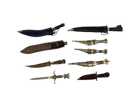 A collection of nine various daggers, comprising a kukri, several eastern examples and a double edged Taylor of Sheffield exa