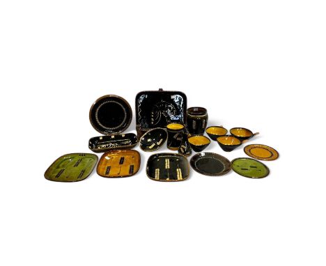 A collection of Coldstone pottery, predominately decorated in white on a black ground, comprising plates, platter, vases, bow