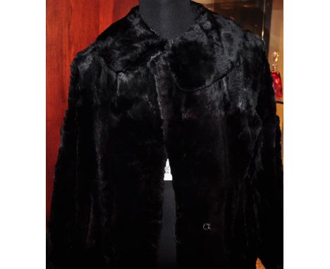 A ladies vintage black fur short jacket together with two brown fur jackets and a black faux fur coat