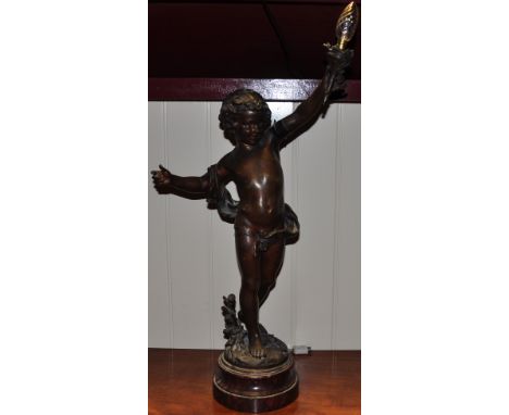 An early 20th Century bronzed spelter table lamp, modelled as a cherub bearing a torch on variegated red marble plinth, h:70c