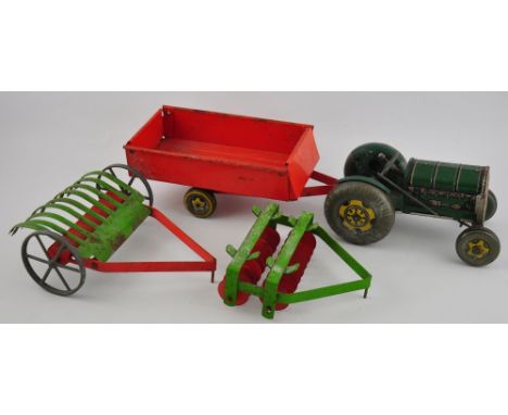 A vintage tinplate clockwork toy tractor together with a trailor, a harrow and a roller, unbranded