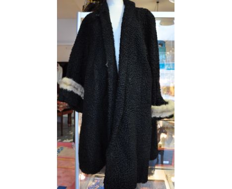 A ladies vintage Astakhan fur coat with fur cuffs