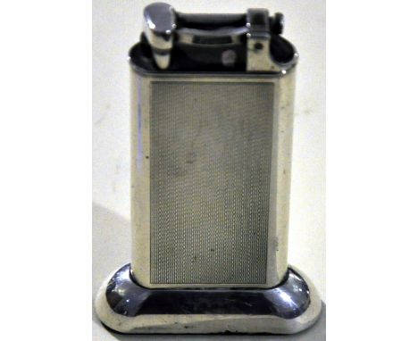 An early 20th Century Dunhill silver plated tallboy cigarette lighter with engine turned body