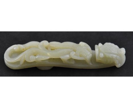 A Chinese jade belt buckle in the form of a dragon and leopard