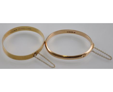 A 9ct yellow gold engraved bangle , together with another similar 15ct hinged bangle, 25grams