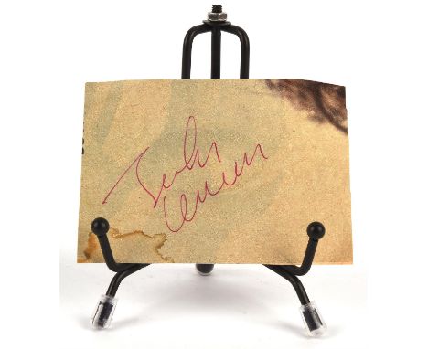 John Lennon autograph - a cutting from a magazine bearing John Lennon's signature in red biro Condition Report:  Stating and 