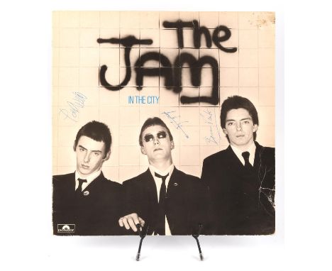 The Jam - In The City album sleeve signed to the front in biro by Paul Weller, Rick Buckler and Bruce Foxton. Condition Repor