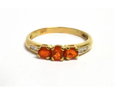 A FIRE OPAL THREE STONE 9CT GOLD RING  The three oval cut fire opals approx. 4.5mm x 3mm, size N, gross weight approx. 1.6 gr