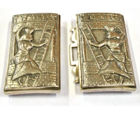 A WHITE METAL BELT BUCKLE WITH EGYPTIAN FIGURE DECORATION Both sections with embossed scene of Egyptian figure and wall ladde