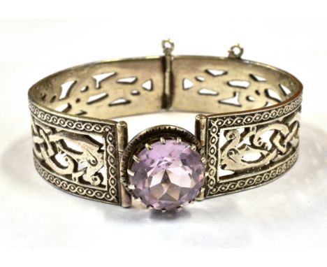 A SCOTTISH SILVER AMETHYST SET BANGLE  The celtic design bangle with large round cut amethyst to front, 14mm diameter, the hi