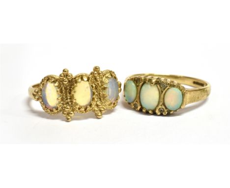 TWO OPAL THREE STONE 9CT GOLD RINGS  One with a boat shaped head, tiny diamonds between, size O; the other with rope twist de