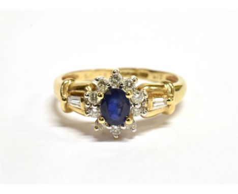 A SAPPHIRE AND DIAMOND OVAL CLUSTER RING  the central oval cut sapphire approx. 5 x 4mm weighing approx. 0.5 carats, a surrou