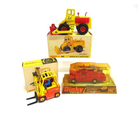 THREE DINKY DIECAST MODEL VEHICLES  comprising a Dinky No.282, Land Rover Fire Appliance, red with unpainted metal hubs, near