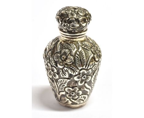 A VICTORIAN SILVER MINIATURE SCENT FLASK The bottle form flask with all over embossed foliate decoration with hinged domed li