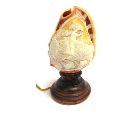 A CARVED CONCH SHELL TABLE LAMP  early 20th century, decorated with a cameo style classical scene inscribed 'Ebe Giove', with