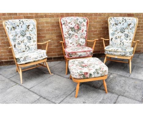 THREE MATCHING LIGHT ERCOL BEECH FRAMED ARMCHAIRS  73cm wide across arms, 104cm high; together with a matching footstool Cond