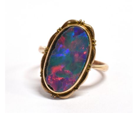 A 19th CENTURY OPAL DOUBLET SIGNET RING   The oval black opal doublet 13mm x 7mm, bezel set, the closed back setting stamped 