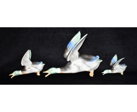 POOLE POTTERY: A SET OF THREE GRADUATED DUCK WALL PLAQUES, stamped 812-1, 812-2, 812-3, the largest 30cm long Condition Repor