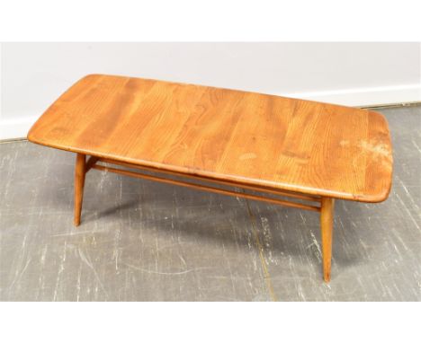 A LIGHT ERCOL COFFEE TABLE with magazine rack undertier, the rectangular top 105cm x 44cm Condition Report : solid, but water