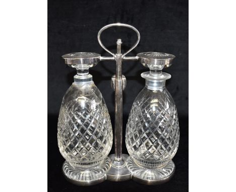 STYLE OF CHRISTOPHER DRESSER:  A Hukin &amp; Heath two bottle Tantalus with silver plated frame, stamped marks and number '65