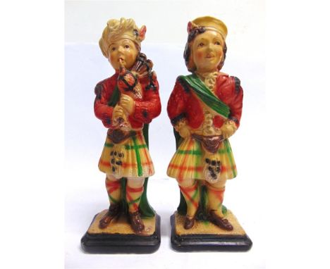 A PAIR OF PLASTER SCOTTISH FIGURES  circa 1930, in traditional attire, with a hand- and spray-painted finish, each approximat