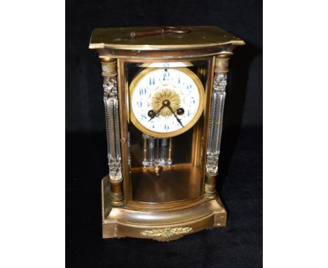 A FRENCH BRASS CASED MANTLE CLOCK BY SAMUEL MARTI &amp; CO with bevelled glass throughout and bowed glass flanked by cut glas