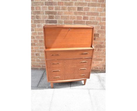 A 1960S TEAK G-PLAN STYLE BUREAU  the fall front opening to fitted interior, above four drawers with resessed pull handles, 7