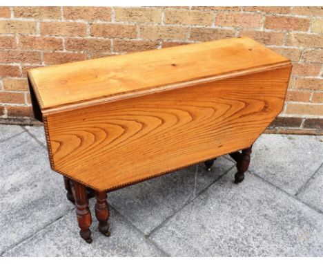 LIGHT OAK DROP FLAP TABLE, of hexagonal form