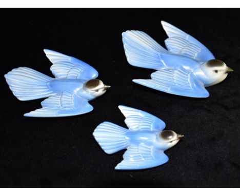 POOLE POTTERY: A SET OF THREE GRADUATED 'BLUEBIRD' WALL PLAQUES, stamped 807-1, 807-2, 807-3, the largest 15cm long Condition