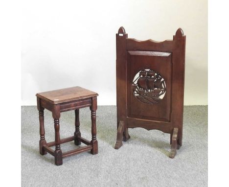 An Arts and Crafts oak firescreen, decorated with a ship, 44cm wide, together with an oak stool (2)