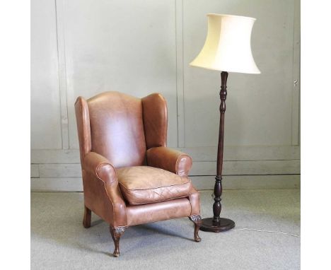 A modern brown leather upholstered armchair, on cabriole legs, together with a standard lamp and shade (2)