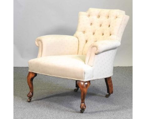 A 1920's cream upholstered button back armchair, on cabriole legs73cm wide